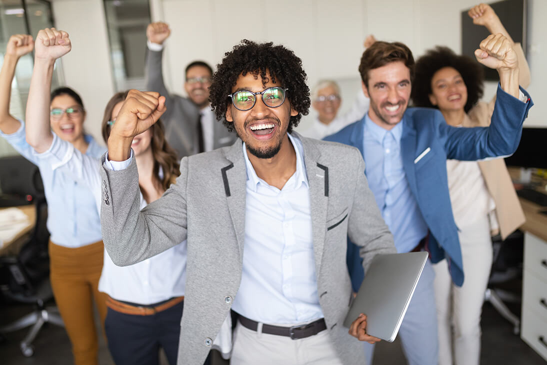Happy business people celebrating success at work